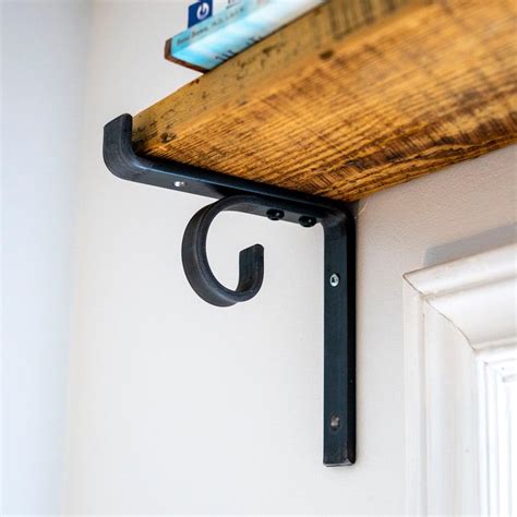 pine shelf with metal brackets|curtain rod and shelf bracket.